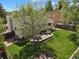Expansive backyard with mature trees, a patio, and a dining set at 7466 E Long Cir, Centennial, CO 80112
