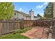 Fenced backyard with stone patio and a tranquil seating area at 7466 E Long Cir, Centennial, CO 80112