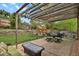 Backyard patio with pergola, dining set, and outdoor lounge area at 7466 E Long Cir, Centennial, CO 80112