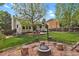 Spacious backyard features a fire pit area and mature trees at 7466 E Long Cir, Centennial, CO 80112