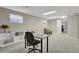 Basement office area with desk, shelving, and natural light at 7466 E Long Cir, Centennial, CO 80112