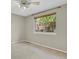 Well-lit bedroom showcasing a large window with a backyard view and neutral carpeting at 7466 E Long Cir, Centennial, CO 80112
