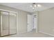 Bright bedroom featuring a mirrored closet and a doorway to an adjacent room at 7466 E Long Cir, Centennial, CO 80112