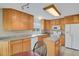 Sunlit kitchen showcasing wooden cabinets, granite countertops, an island, and modern appliances at 7466 E Long Cir, Centennial, CO 80112