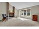 Inviting living room with a brick fireplace, large windows, and neutral carpet, creating a cozy atmosphere at 7466 E Long Cir, Centennial, CO 80112