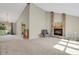 Bright living room featuring a brick fireplace, high ceilings, neutral tones, and ample natural light at 7466 E Long Cir, Centennial, CO 80112