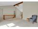 Open-concept living area featuring vaulted ceilings, neutral tones, and access to upper level of the home at 7466 E Long Cir, Centennial, CO 80112