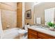 Well-maintained bathroom features tiled walls, a shower-tub, and a wooden vanity with granite countertops at 10156 Nottingham Dr, Parker, CO 80134
