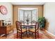 Cozy dining room featuring a bay window, hardwood floors, and stylish furnishings at 10156 Nottingham Dr, Parker, CO 80134
