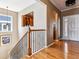 Warm entryway features hardwood floors, iron stair railing, and view to kitchen at 10156 Nottingham Dr, Parker, CO 80134