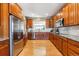 Bright kitchen featuring wood cabinets, granite counters, and stainless steel appliances at 10156 Nottingham Dr, Parker, CO 80134