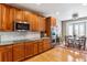 Gourmet kitchen featuring wooden cabinets, granite counters and stainless steel appliances at 10156 Nottingham Dr, Parker, CO 80134