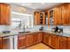 Well-lit kitchen featuring wooden cabinets, granite counters, and modern stainless steel appliances at 10156 Nottingham Dr, Parker, CO 80134
