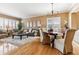 Open-concept living room featuring hardwood floors, a cozy rug, and abundant natural light at 10156 Nottingham Dr, Parker, CO 80134