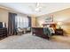 Spacious primary bedroom featuring a ceiling fan, plush carpeting, and plenty of natural light at 10156 Nottingham Dr, Parker, CO 80134