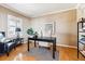 This home office features hardwood floors, stylish decor and neutral paint at 10156 Nottingham Dr, Parker, CO 80134