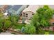Aerial view of a well-maintained home featuring a large backyard, mature trees, and a spacious patio at 10191 Sagecrest St, Highlands Ranch, CO 80126