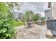 Cozy backyard patio features an outdoor dining set, lush greenery, and houses in the background at 10191 Sagecrest St, Highlands Ranch, CO 80126