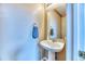 Powder room featuring pedestal sink, framed mirror, and neutral wall color at 10191 Sagecrest St, Highlands Ranch, CO 80126