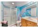 Bathroom featuring colorful walls, a glass-enclosed shower, and a wooden vanity with ample storage space at 10191 Sagecrest St, Highlands Ranch, CO 80126