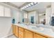 Well-lit bathroom featuring double sinks and a large mirror, creating a bright and functional space at 10191 Sagecrest St, Highlands Ranch, CO 80126