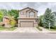 Charming two-story home featuring a well-manicured front yard and an attached two-car garage at 10191 Sagecrest St, Highlands Ranch, CO 80126