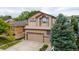 Traditional two-story home featuring a well-kept lawn and attached two-car garage at 10191 Sagecrest St, Highlands Ranch, CO 80126