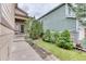 Well-maintained front yard featuring lush landscaping, manicured trees, and a charming walkway to the front door at 10191 Sagecrest St, Highlands Ranch, CO 80126