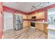 Kitchen area featuring stainless steel appliances, wood cabinets, and laminate flooring at 10191 Sagecrest St, Highlands Ranch, CO 80126
