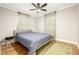 Inviting bedroom with hardwood floors, ceiling fan, and sunlit windows with sheer drapes at 725 E Bayaud Ave, Denver, CO 80209