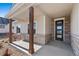 Inviting covered porch features stone accents, wood columns, and a stylish front door at 1402 Burt Ave, Berthoud, CO 80513