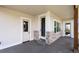 Covered porch showcasing multiple doors and windows, providing ample natural light and access at 1402 Burt Ave, Berthoud, CO 80513