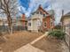 Backyard featuring a well-manicured lawn and the rear exterior of the home at 3833 Umatilla St, Denver, CO 80211