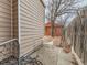 Side yard view with a small orange outbuilding and a fenced-in area at 3833 Umatilla St, Denver, CO 80211