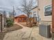 Backyard featuring a charming orange outbuilding, patio, and well-maintained landscaping at 3833 Umatilla St, Denver, CO 80211