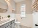 Elegant powder room with modern vanity, round mirror, and decorative accents at 3833 Umatilla St, Denver, CO 80211