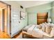 Bright bedroom with hardwood floors, a closet, and decorative painting on the wall at 3833 Umatilla St, Denver, CO 80211