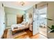 Light-filled bedroom featuring hardwood floors, large windows, and an accent wall at 3833 Umatilla St, Denver, CO 80211