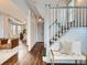 Inviting entryway with hardwood floors leading to the living room and staircase at 3833 Umatilla St, Denver, CO 80211