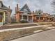 Beautiful red brick home featuring a cozy front porch and classic architectural details at 3833 Umatilla St, Denver, CO 80211