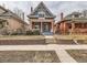 Charming two-story brick home with inviting front porch and manicured lawn at 3833 Umatilla St, Denver, CO 80211