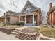 Attractive brick home with a welcoming front porch, perfect for relaxing outdoors at 3833 Umatilla St, Denver, CO 80211