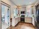 Well-lit kitchen with gray cabinets, stainless steel appliances, and hardwood floors at 3833 Umatilla St, Denver, CO 80211