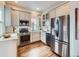 Modern kitchen featuring stainless steel appliances, and sleek gray cabinetry at 3833 Umatilla St, Denver, CO 80211