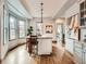 Bright kitchen island with seating, natural light from large windows, and wooden countertop at 3833 Umatilla St, Denver, CO 80211