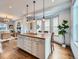 Open-concept kitchen island with wood countertop, pendant lighting, and hardwood floors at 3833 Umatilla St, Denver, CO 80211