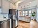 Spacious kitchen featuring a large island with wooden countertop and stainless steel appliances at 3833 Umatilla St, Denver, CO 80211