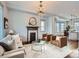 Elegant living room with fireplace, chandelier, and comfortable seating at 3833 Umatilla St, Denver, CO 80211