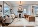 Cozy living room featuring a decorative fireplace, plush seating, and natural light at 3833 Umatilla St, Denver, CO 80211