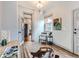 Well-lit home office space, showcasing a desk, chair, and view of a kitchen space at 3833 Umatilla St, Denver, CO 80211